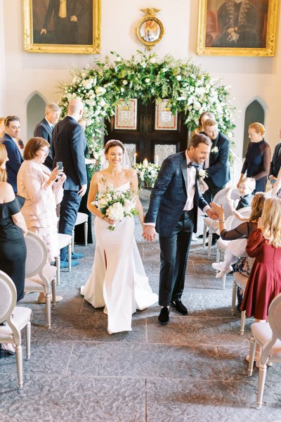 Bride and groom right after wedding ceremony guests clap and cheer