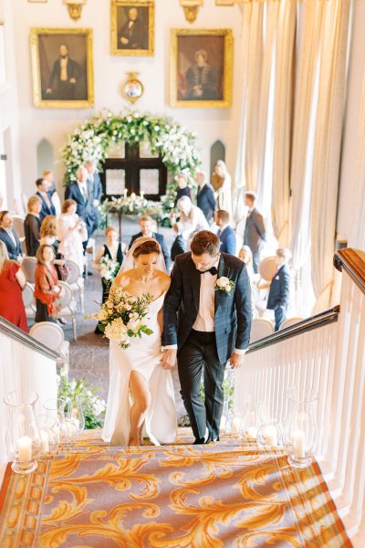 Bride and groom walking up the stairs staircase