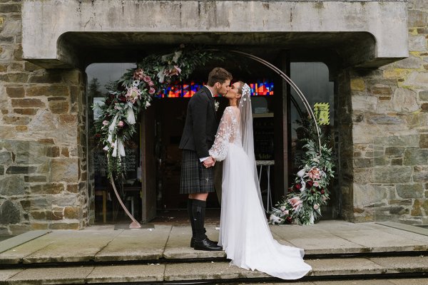 Exterior venue bride and groom steps church ceremony kissing kiss