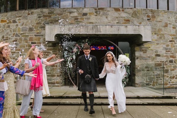 Bride and groom confetti exterior guests