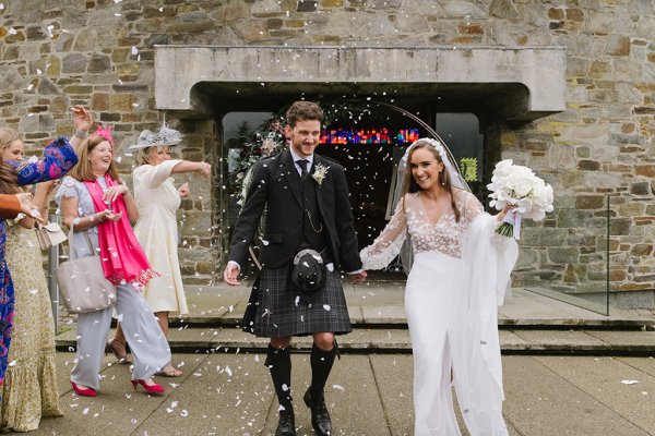 Bride and groom confetti guests