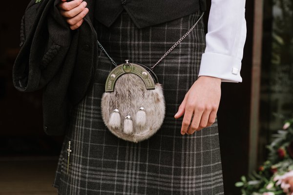 Close up of striped kilt and bagpipe