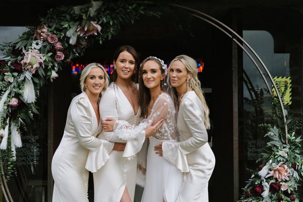 Bridesmaids bride smiling hugging