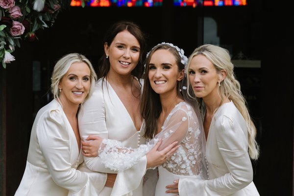 Bridesmaids bride smiling hugging