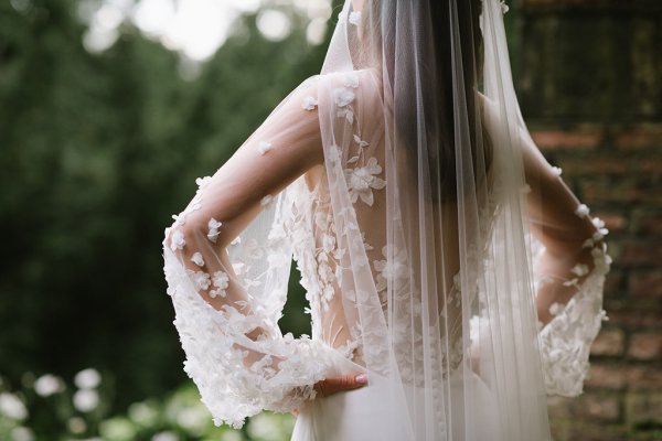 Bride on her own back of dress lace and veil detail