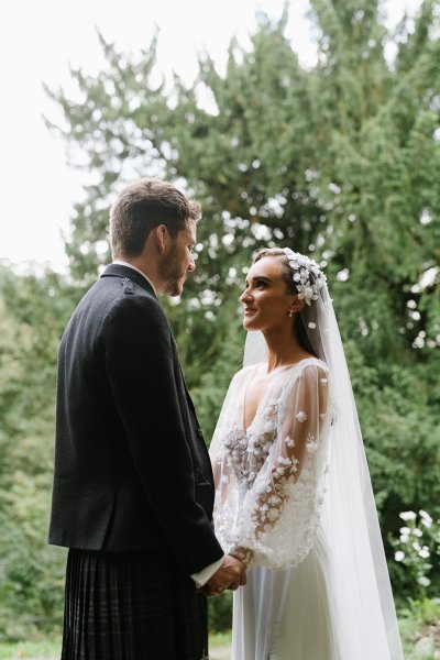 Bride and look in garden looking at each other