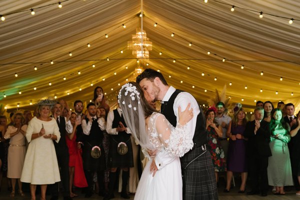 Bride and groom dancefloor kiss kissing embrace