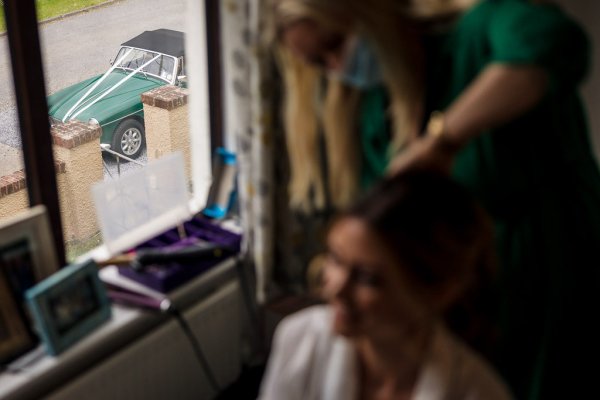 Bride getting ready wedding car detail from window