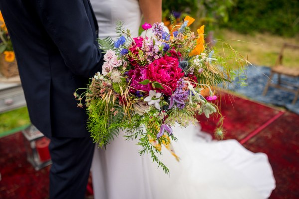 Bride holds bouquet of flowers