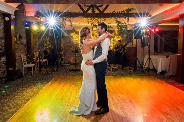 Bride dancing with groom on dancefloor