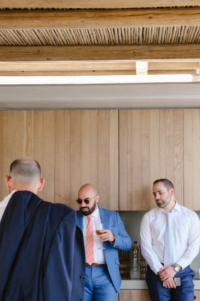 Groom and groomsmen wearing sunglasses interior shot