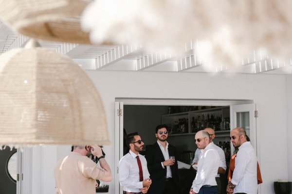 Guests groom groomsmen wearing sunglasses exterior shot