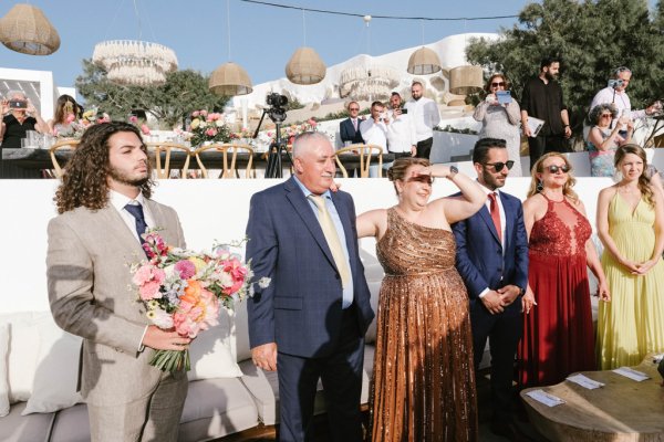 Family holding flowers wearing sunglasses