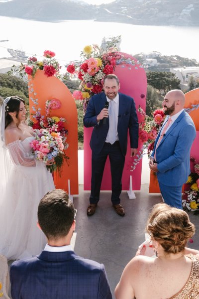 Officiant bride and groom pink floral setting