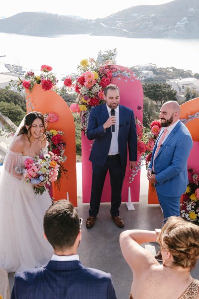 Officiant bride and groom pink floral setting