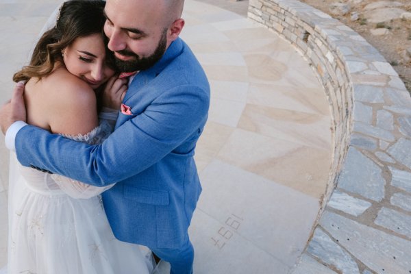 Bride and groom embrace hug exterior shot