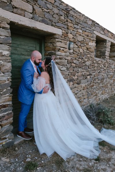 Bricked wall setting with bride and groom facing each other