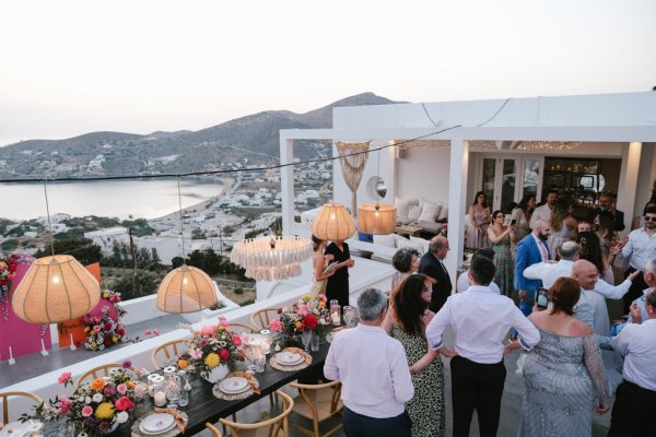 Exterior table dining room setting cutlery and Greek landscape guests