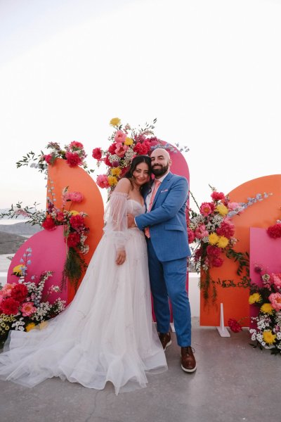 Pink backdrop flowers bride and groom