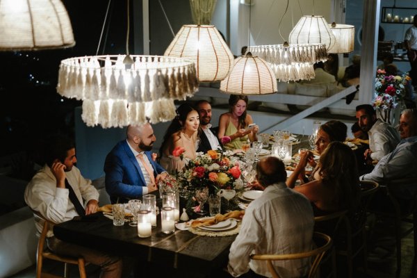 Dining room table family bride groom bouquet of flowers lights interior