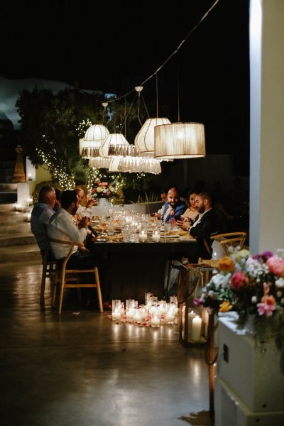 Dining room table family bride groom bouquet of flowers lights interior