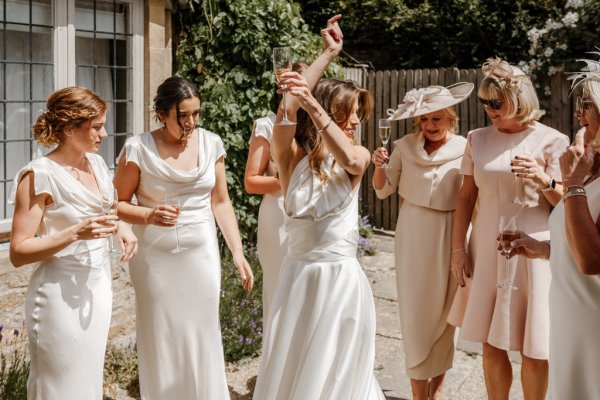 Bride and bridesmaids dance celebrate