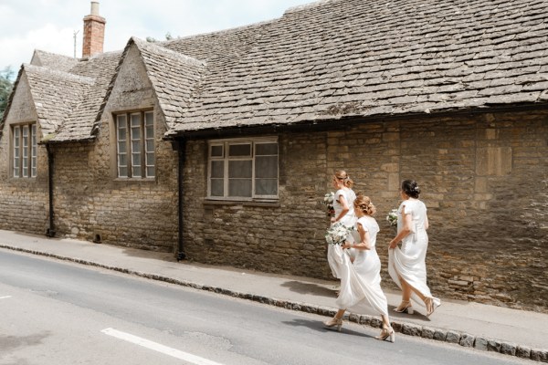 Bridesmaids dresses from behind they walk to venue