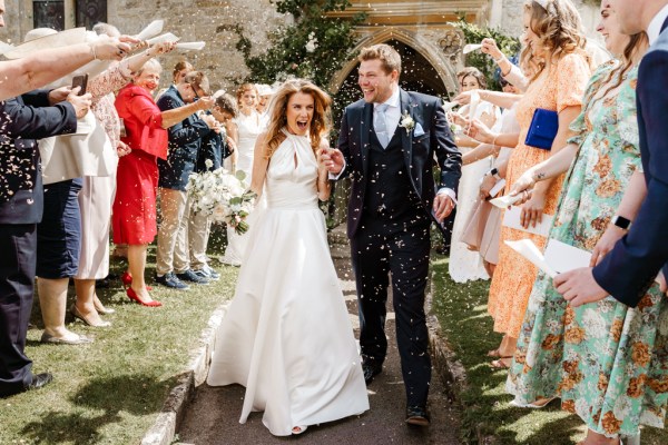 Bride and groom celebrate confetti over couple