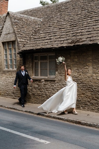 Bride flowers in the air walking with groom