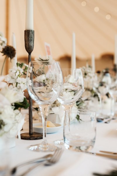 Glasses up close and candles on table