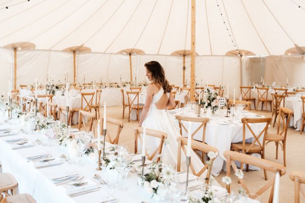 Bride walks through empty dining room