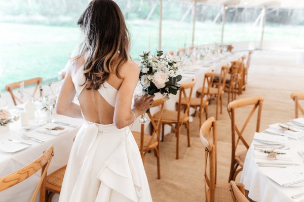 Bride walks through empty dining room