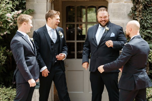 Groom and groomsmen laugh