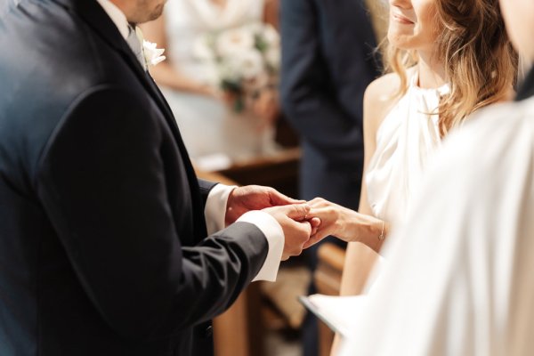 Bride and groom at alter in church holding hands