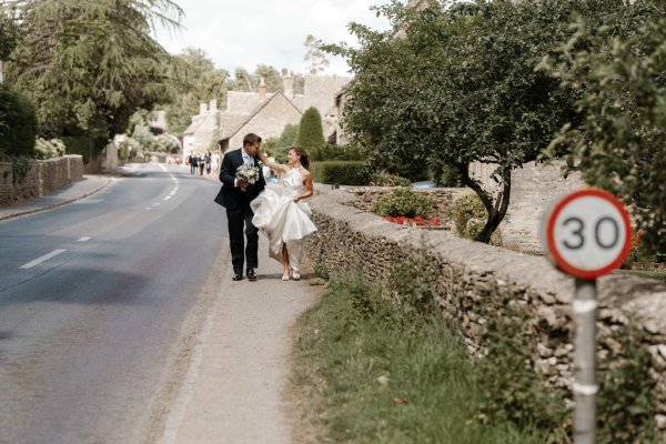 Bride and groom walk outside