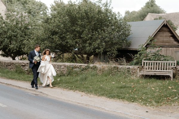 Bride and groom walk outside