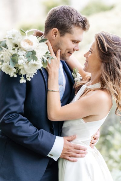 Bride and groom embrace flower detail