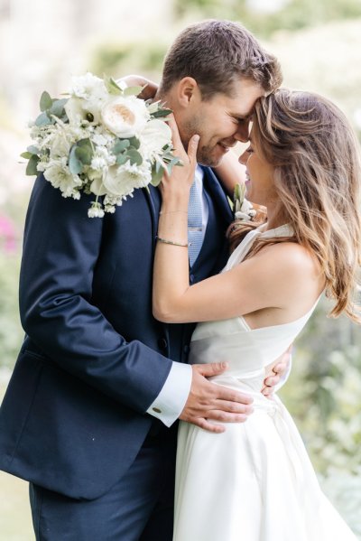 Bride and groom embrace flower detail