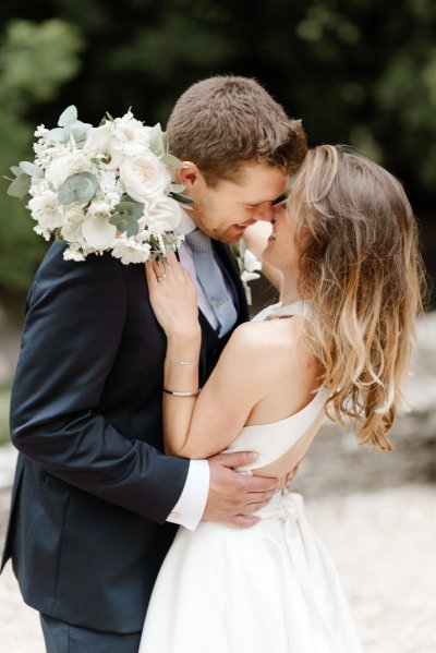 Bride and groom embrace flower detail