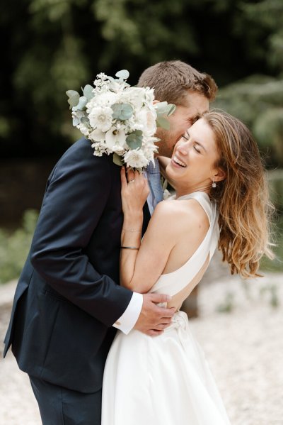 Bride and groom embrace flower detail