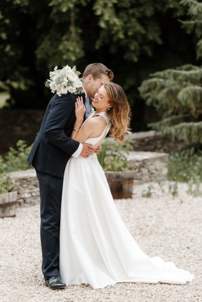 Bride and groom embrace flower detail