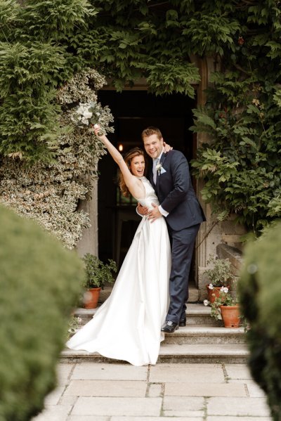 Bride and groom embrace flower detail flowers in the air