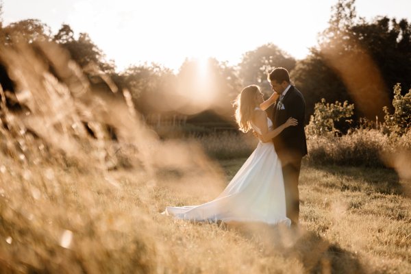 Sun is shining on bride and groom in garden setting