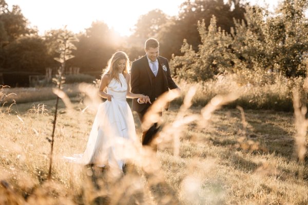 Sun is shining on bride and groom in garden setting