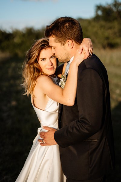 Sun is shining on bride and groom in garden setting