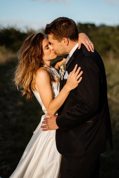 Sun is shining on bride and groom in garden setting