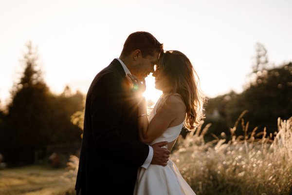 Sun is shining on bride and groom in garden setting