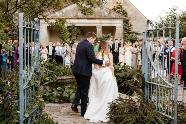 Bride and groom walk back to guests