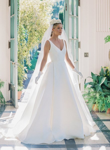 Hat on brides head bridal gown Anne Barge white gloves