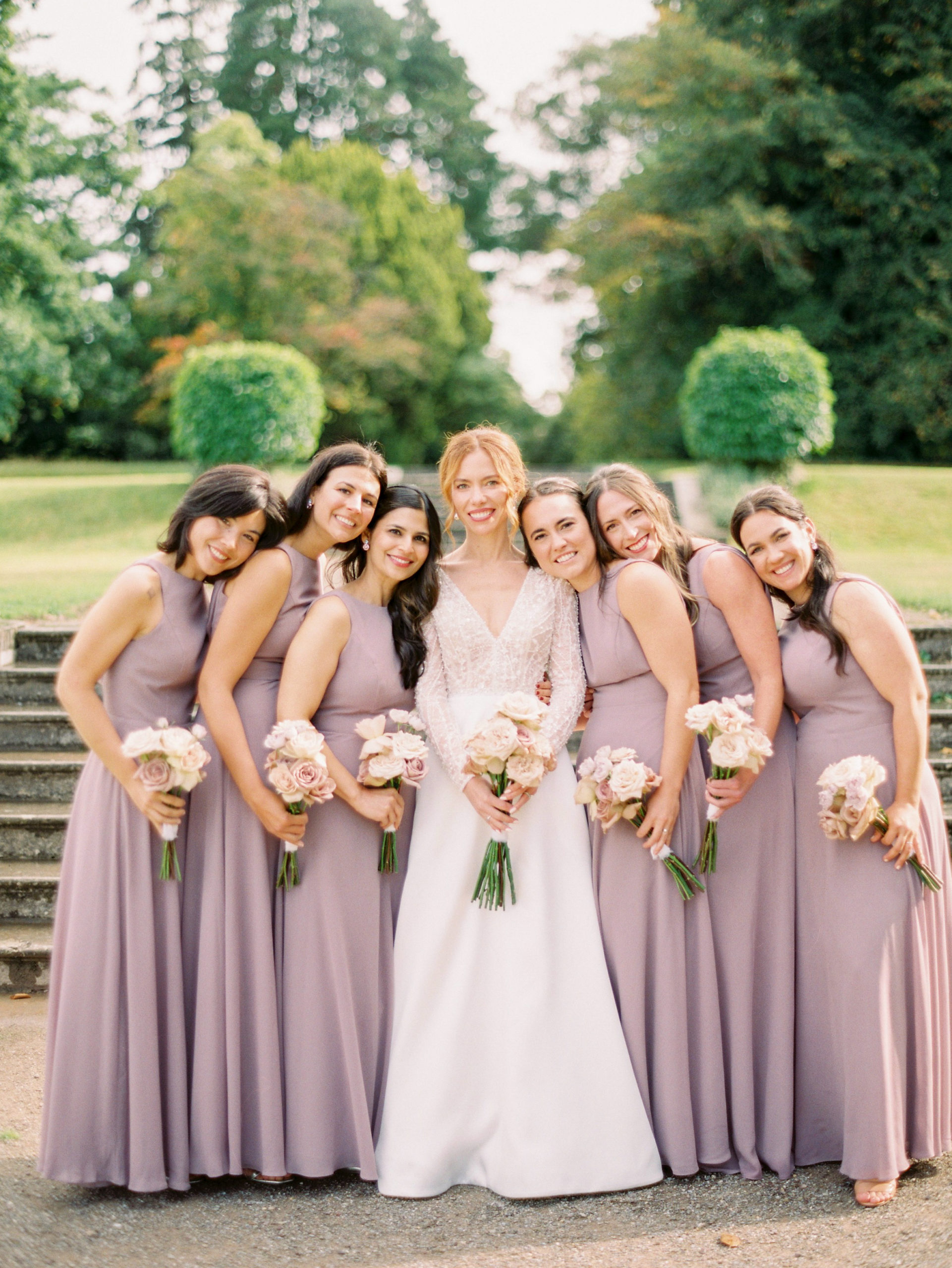 Bride and bridesmaids holding bouquet flowers